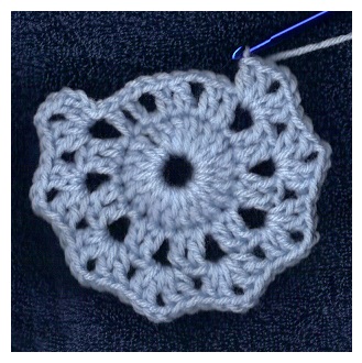 crocheting round three in progress of circle motif from free pattern at sandimarshall.com